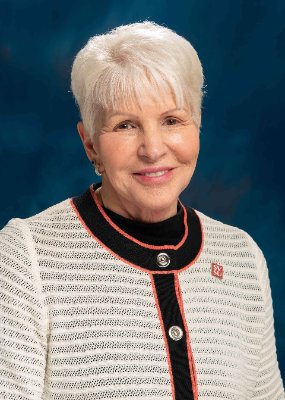 a man and woman standing next to a poster board