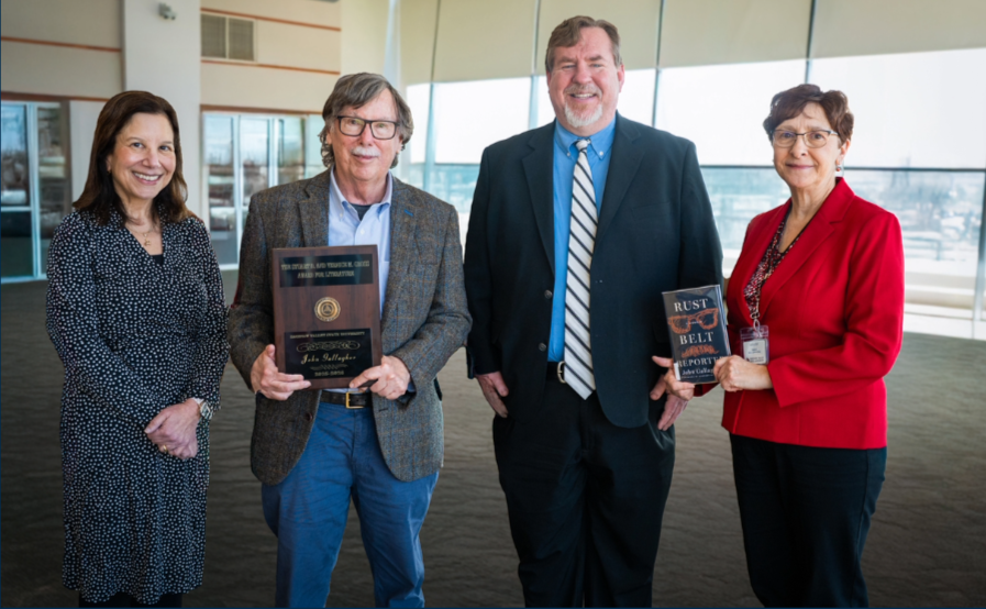a group of people holding awards