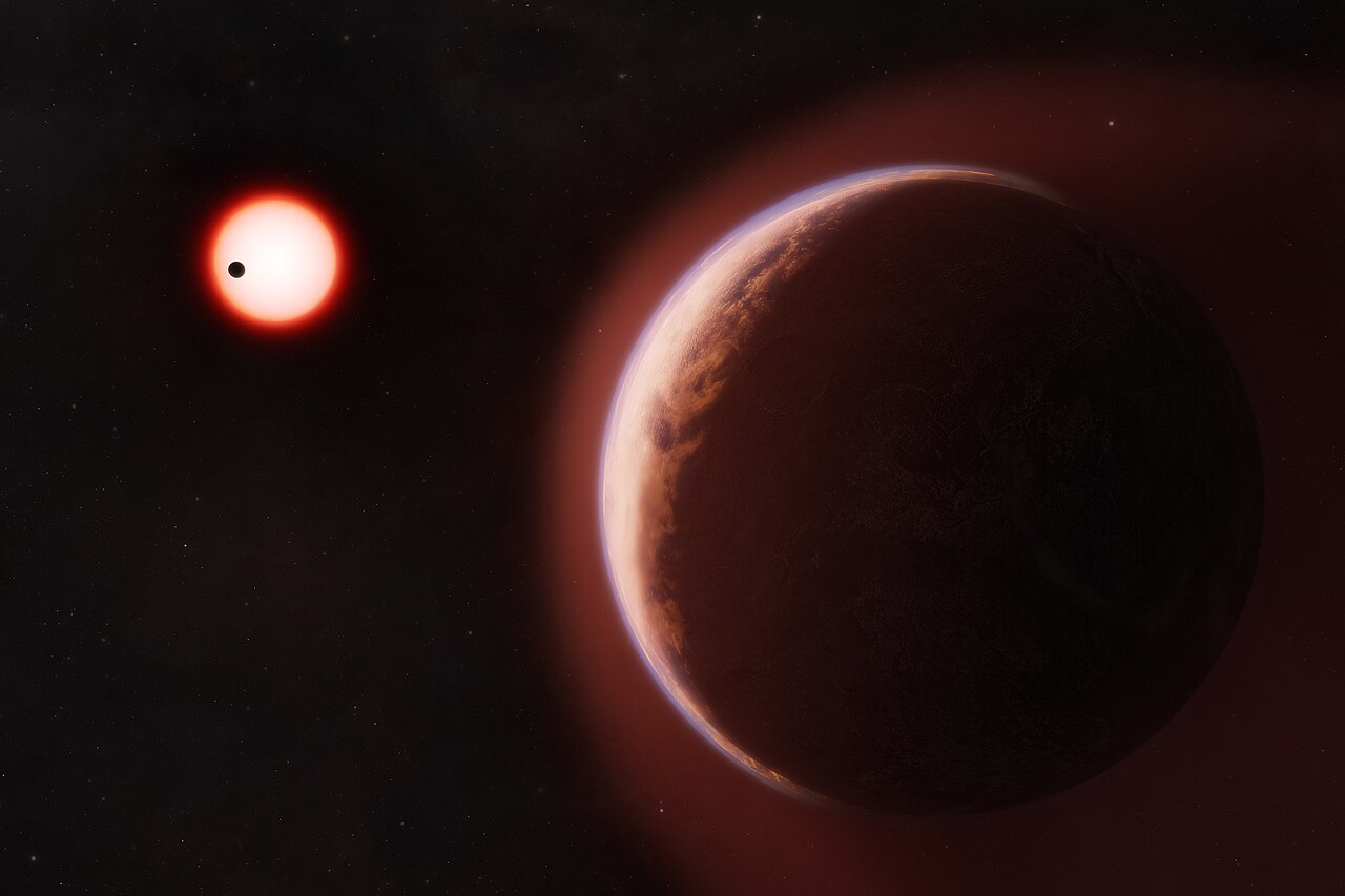 An artist’s concept of exoplanet LHS 1140 b surrounded by a helium-rich atmosphere with a nearby rocky planet orbiting the same cool red dwarf star in the distance.