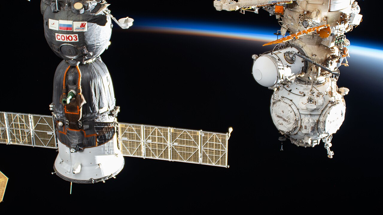 The International Space Station orbits into a sunset 260 miles above China near the Yellow Sea