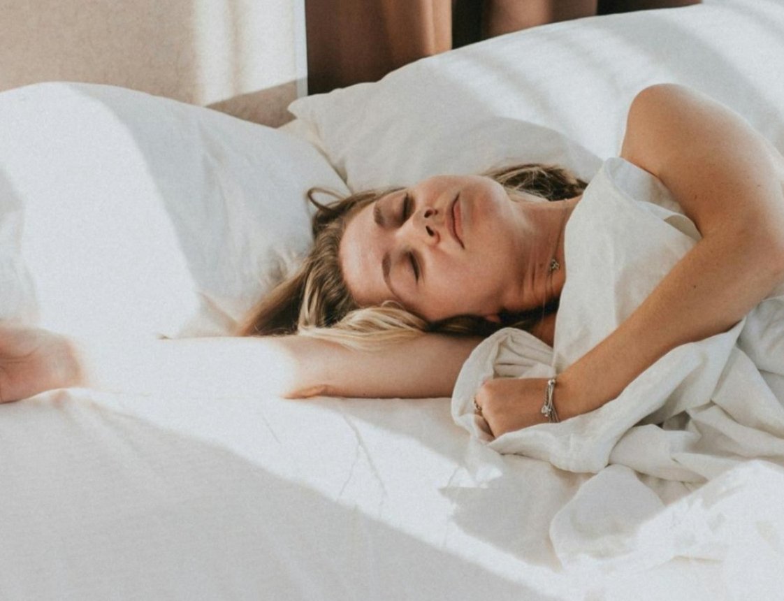 a woman lying in bed with her eyes closed a woman lying in bed with her eyes closed