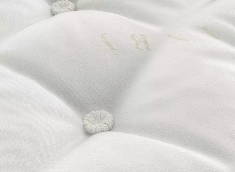 a close up of a white mattress a close up of a white mattress