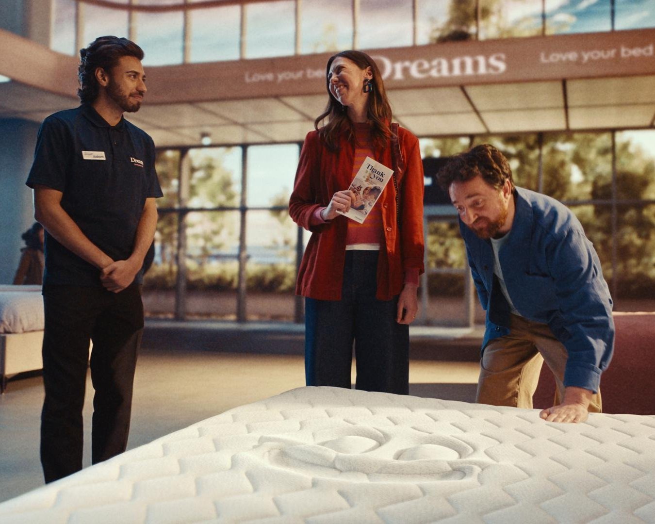 a group of people looking at a mattress a group of people looking at a mattress