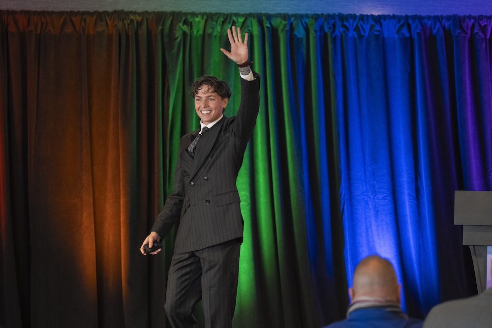 A speaker waving on stage