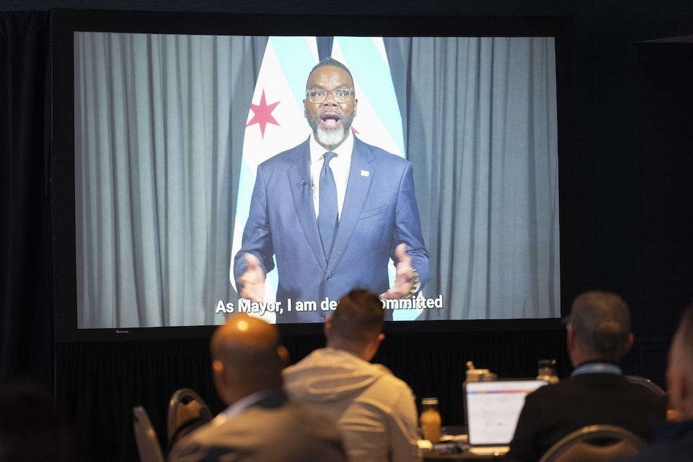 Attendees watching a video message from the Mayor of Chicago