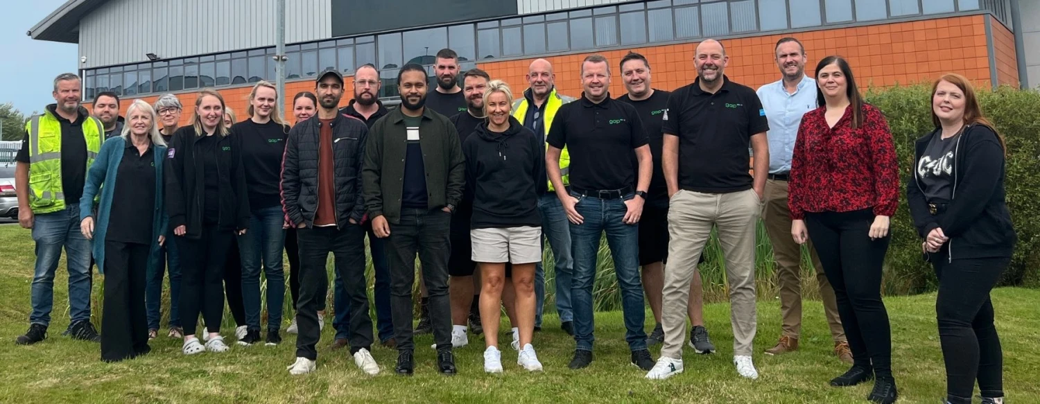 GAP team together outside a depot