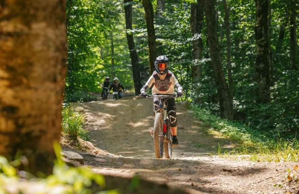 a person riding a bike on a dirt trail