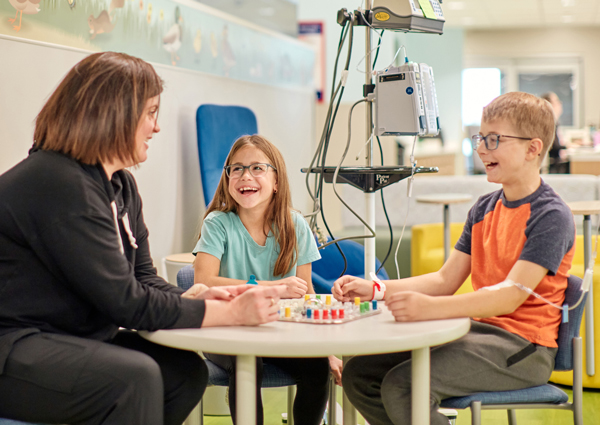 a group of people sitting at a table playing a board game