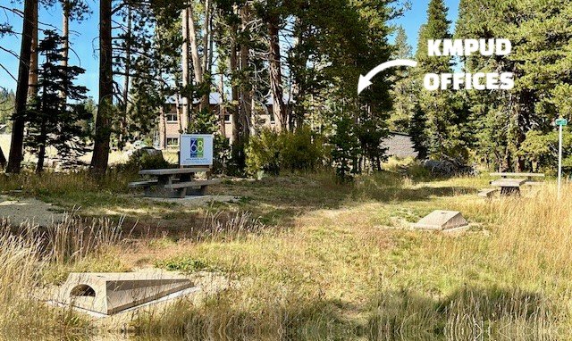a sign in a grassy area