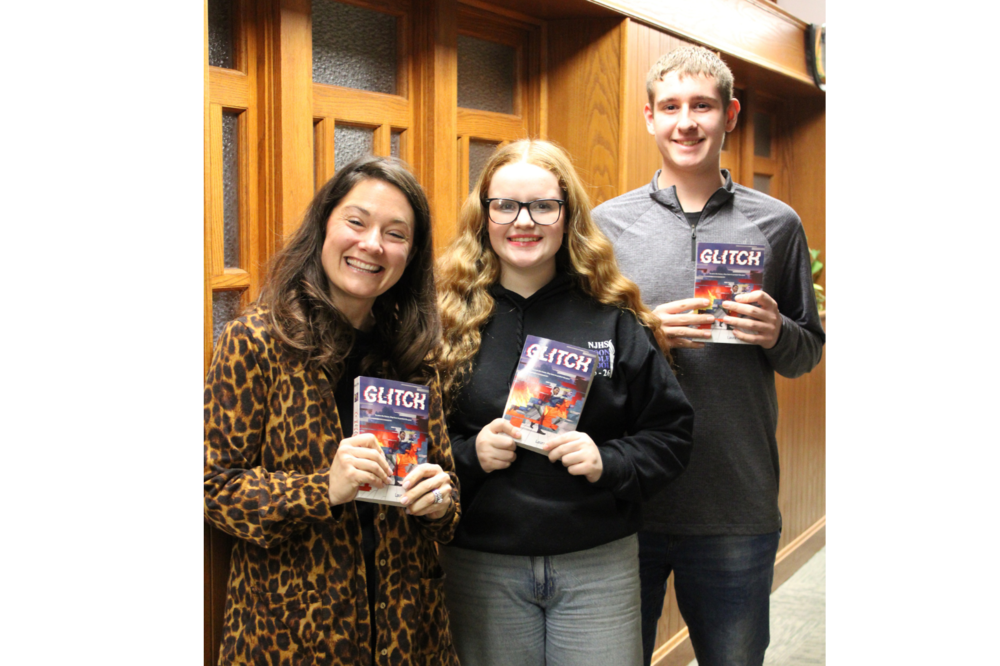 Picture after Board Meeting announcement of the new Read Across Mattoon book. Pictured left to right is MMS teacher Ingrid Minger and students Addison Perkins and Landon Brown. 