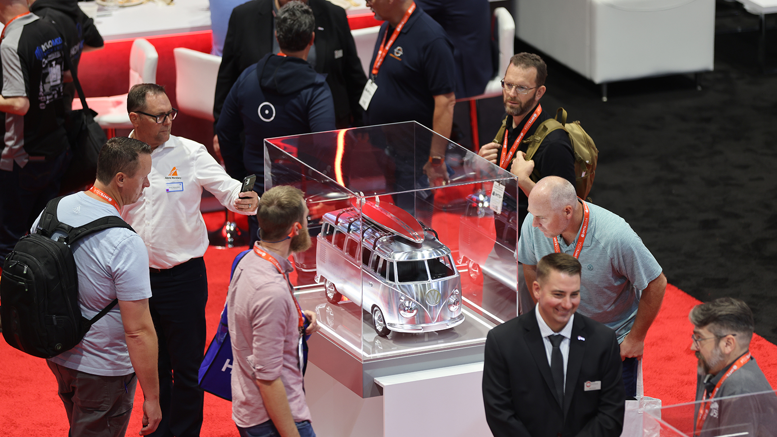 Attendees viewing chrome VW bus model