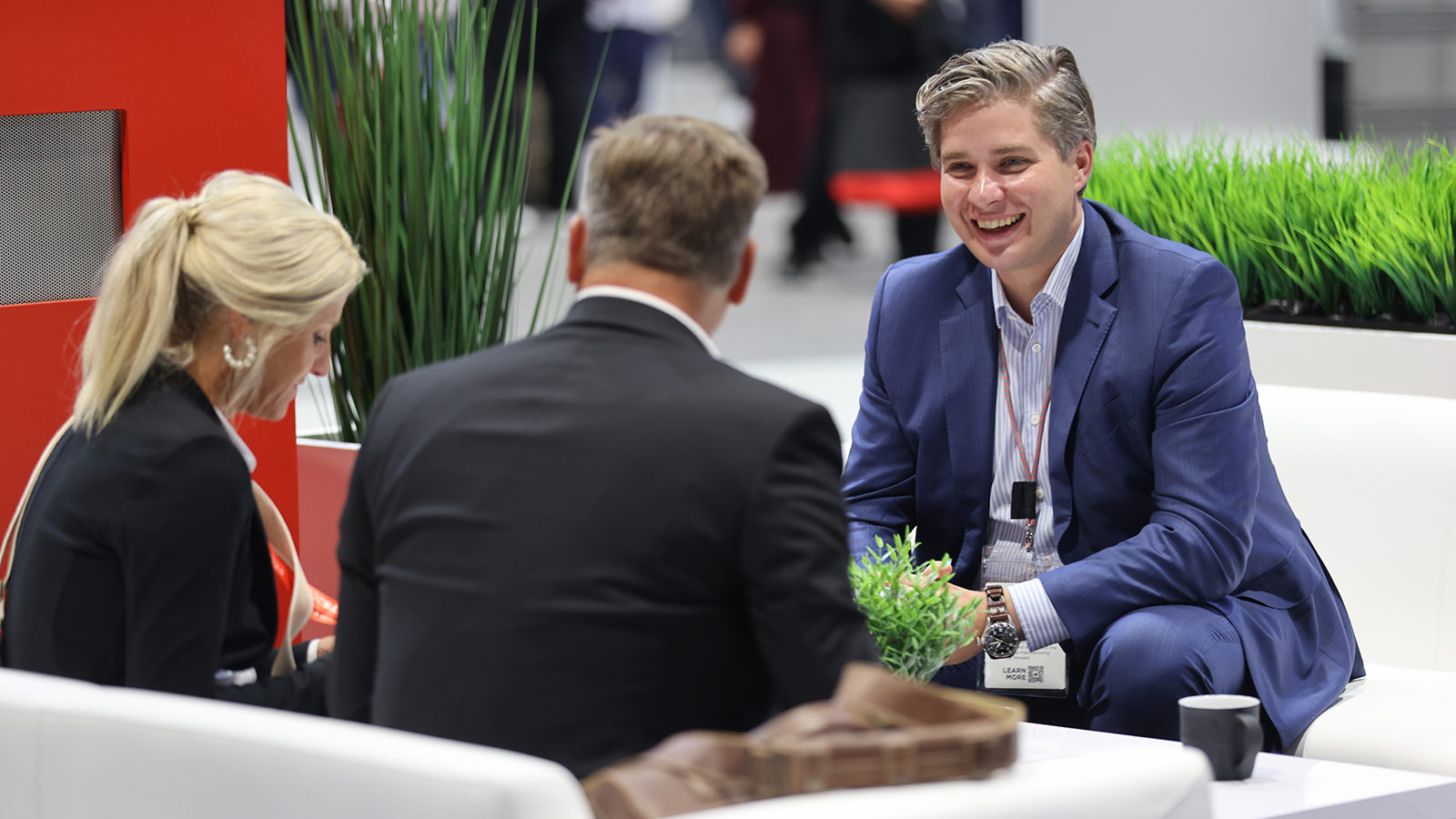 Attendees networking at booth lounge