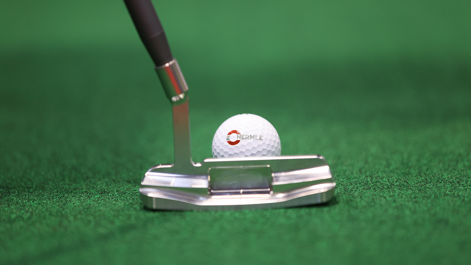 HERMLE branded golf ball and putter