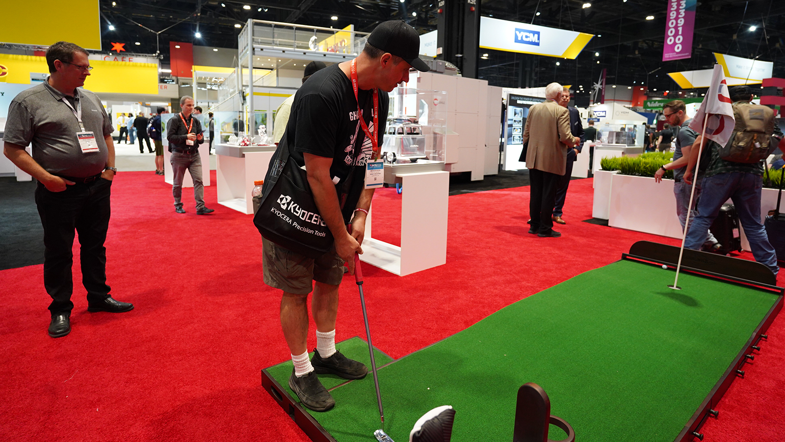 Attendee putting on mini golf green