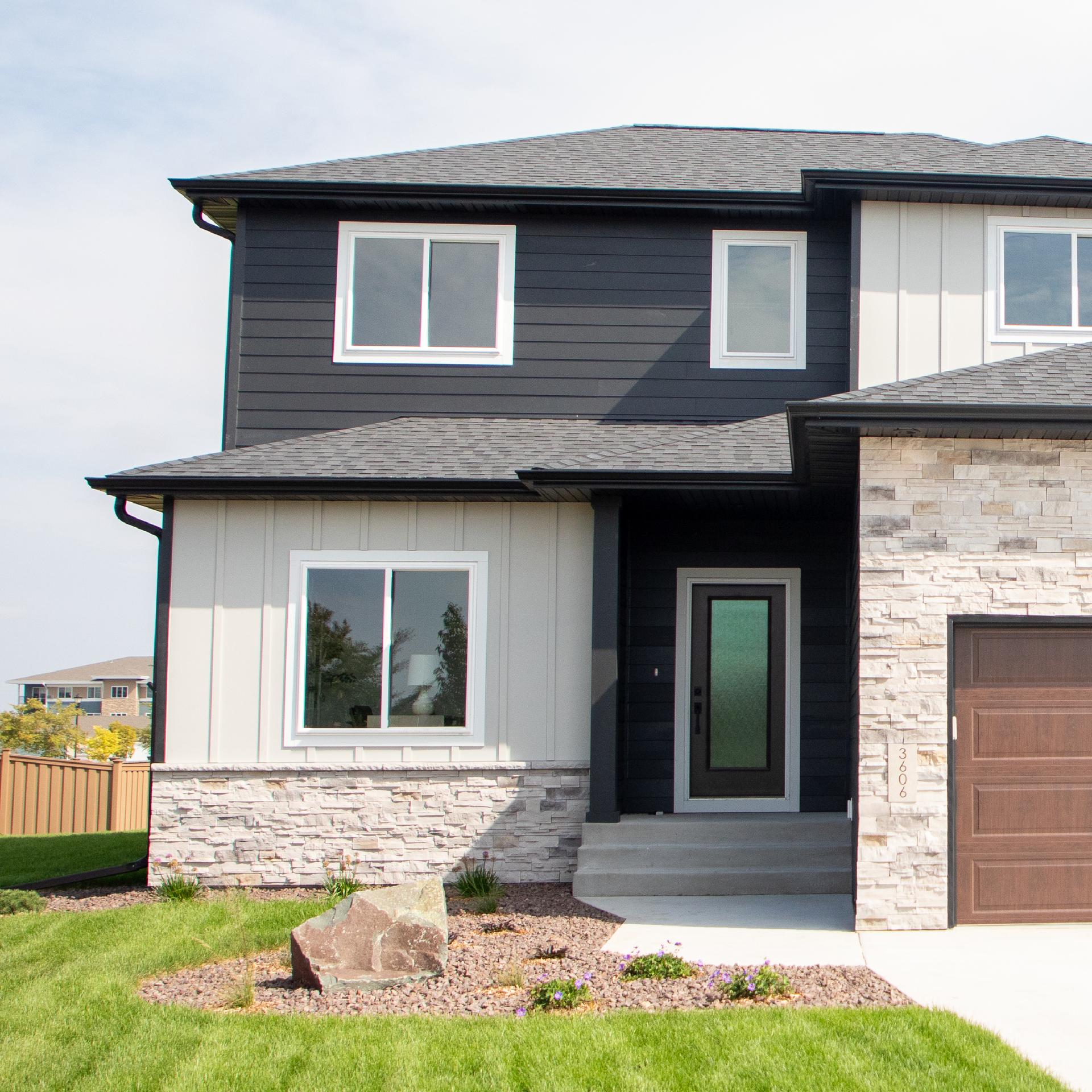 a straw hat and sunglasses on a rock