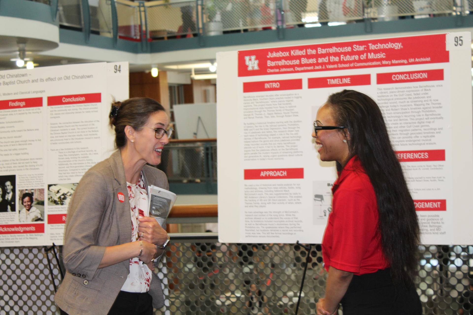 Photo of two women standing in front of research poster.