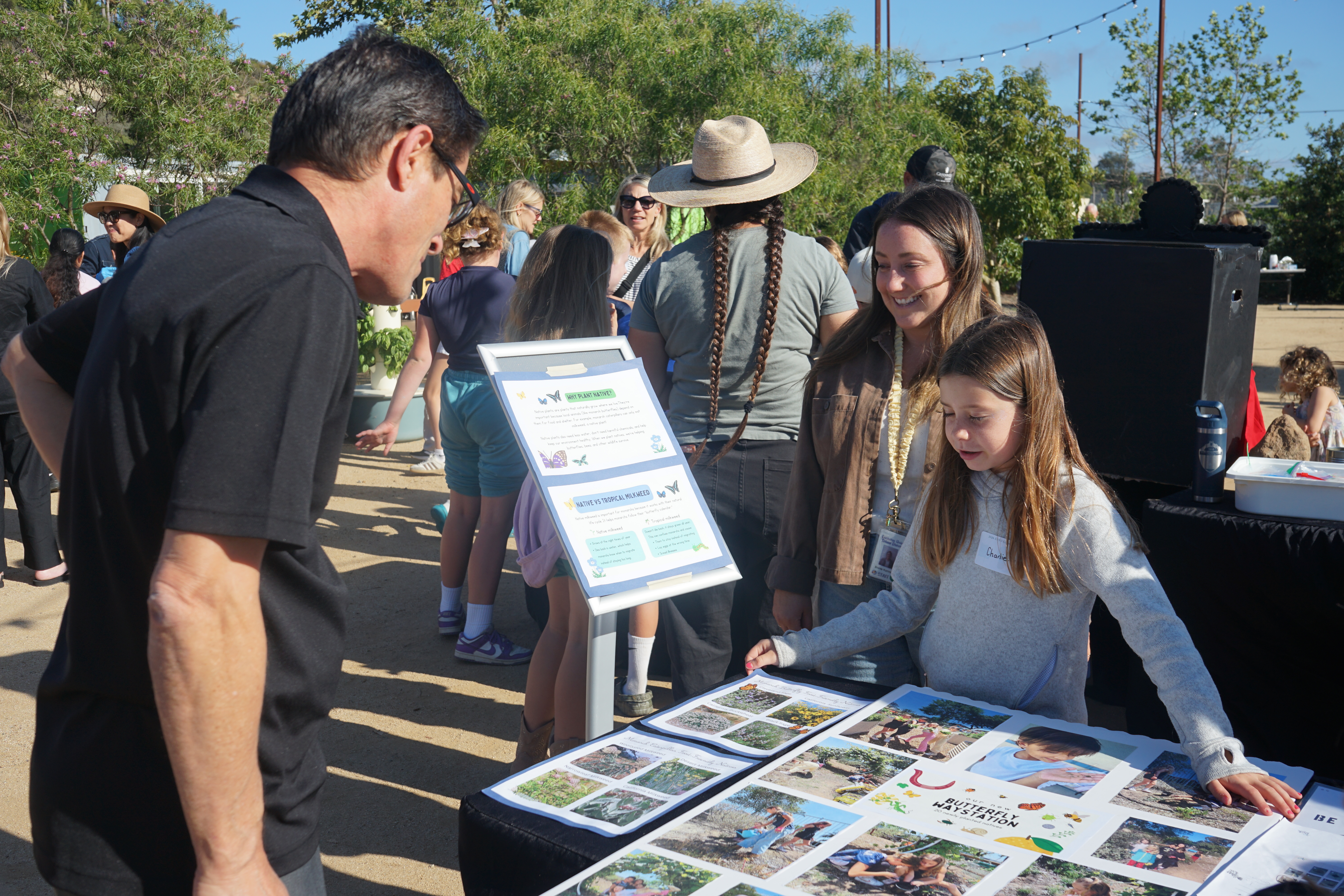 A student tells Principal Chris Juarez about their ecoliteracy fair project.