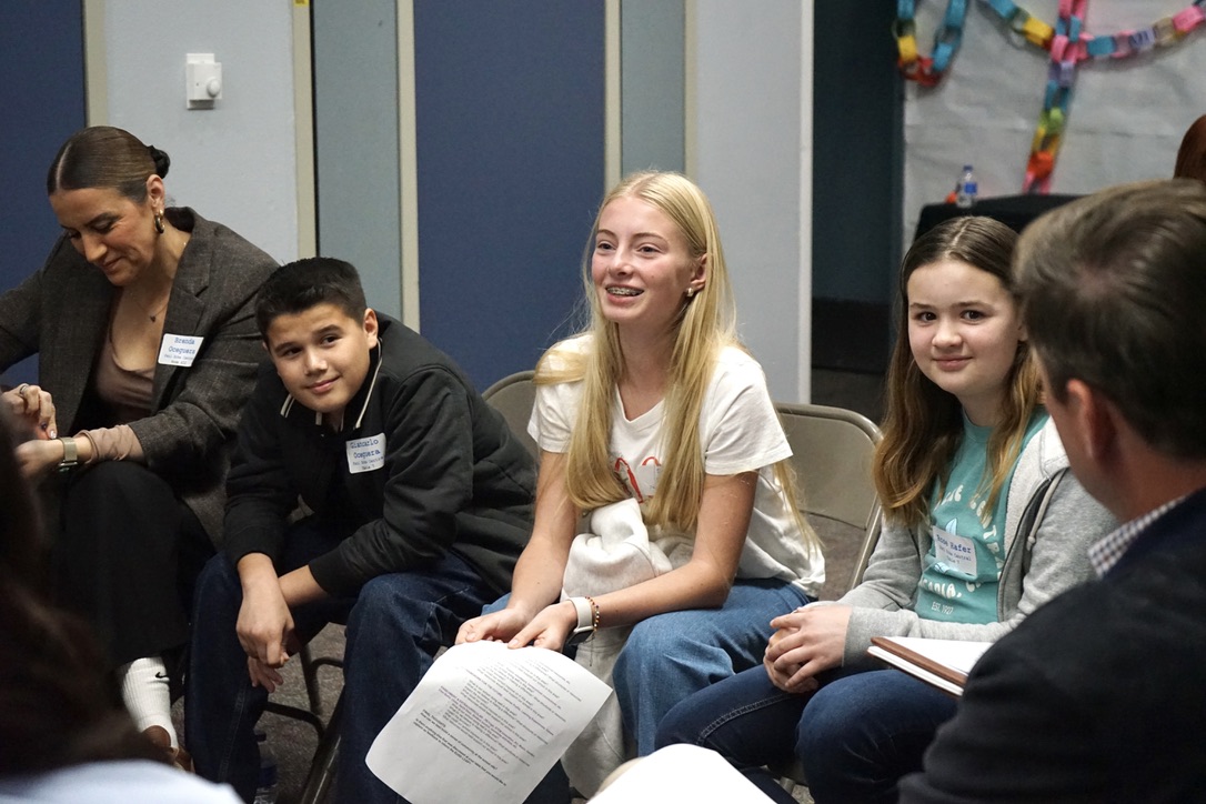 3 students participating as part of a discussion circle. 