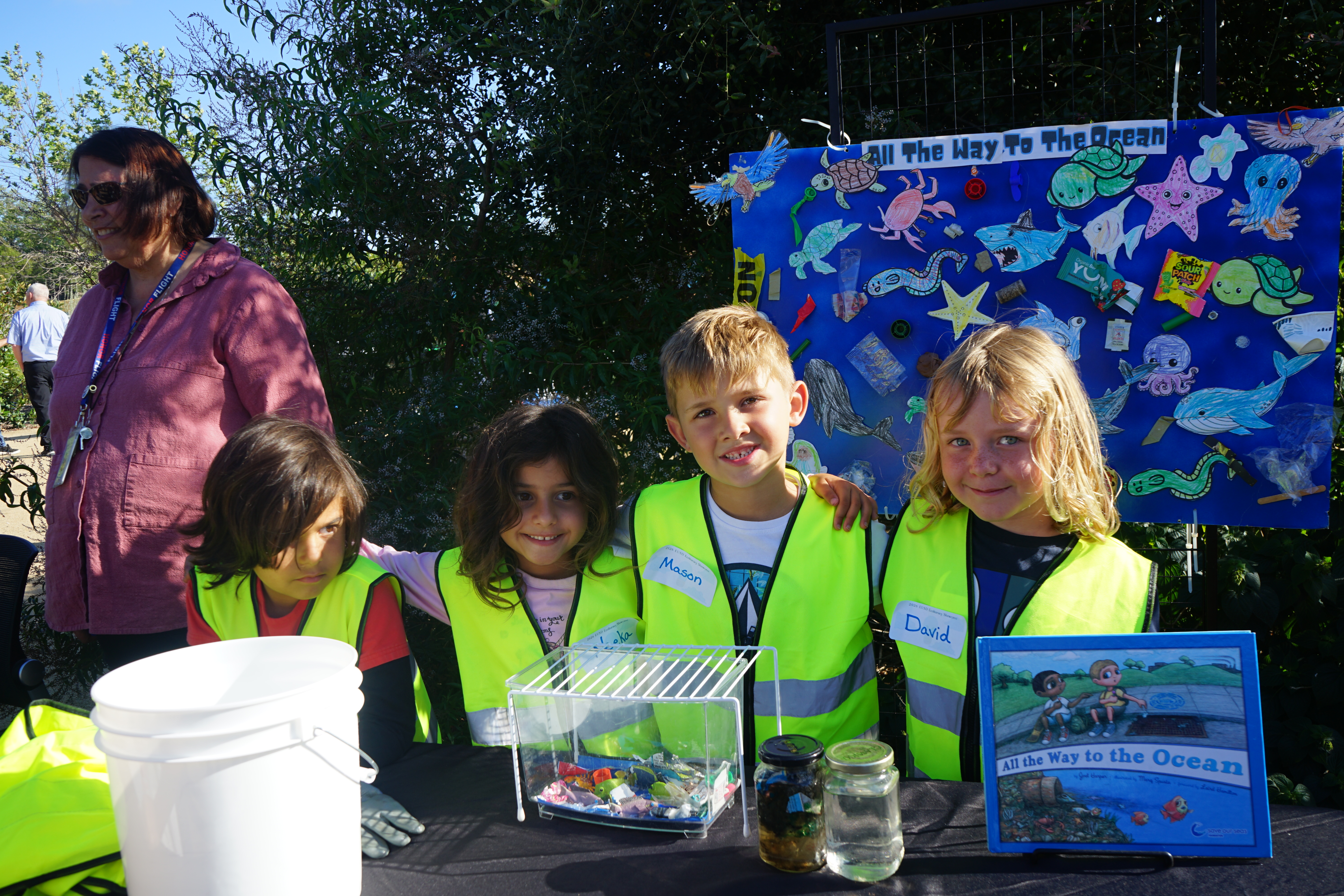 Four young students stand with their clean oceans projects 