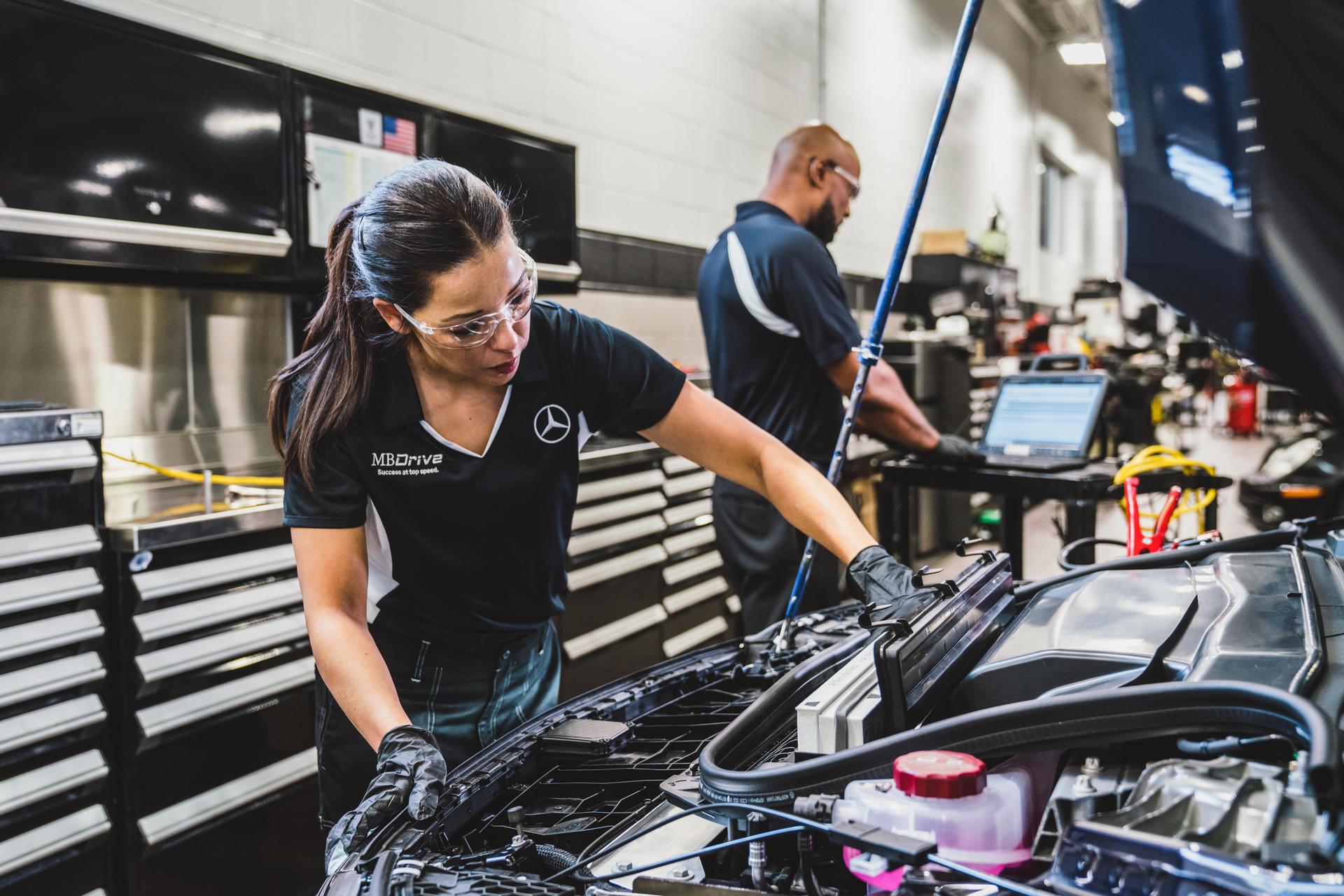 Mercedes-Benz technician performing an underbody inspection