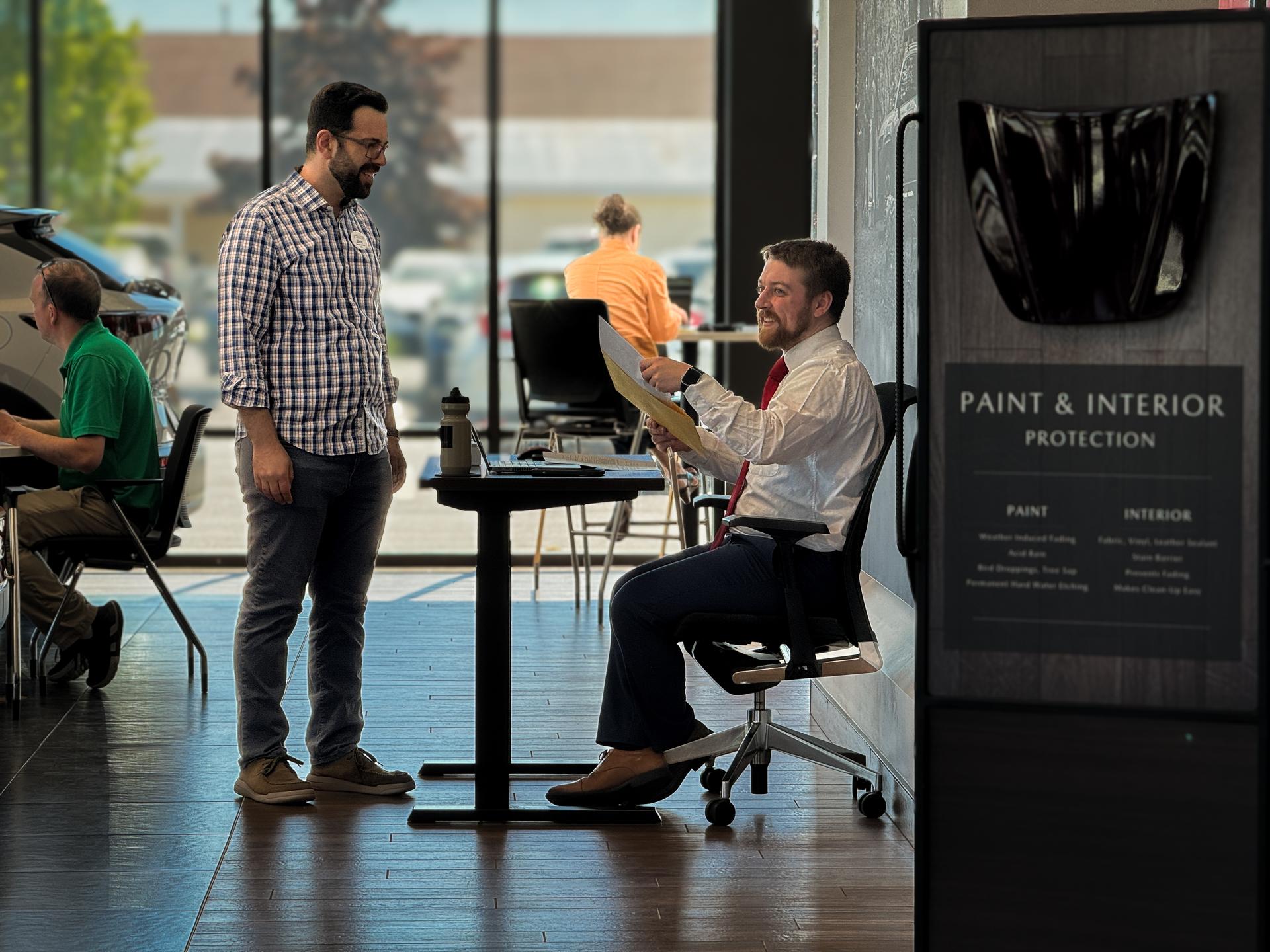 Product Specialist and Guest reviewing at desk
