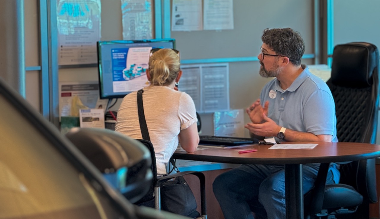 Product Specialist and Guest reviewing at desk