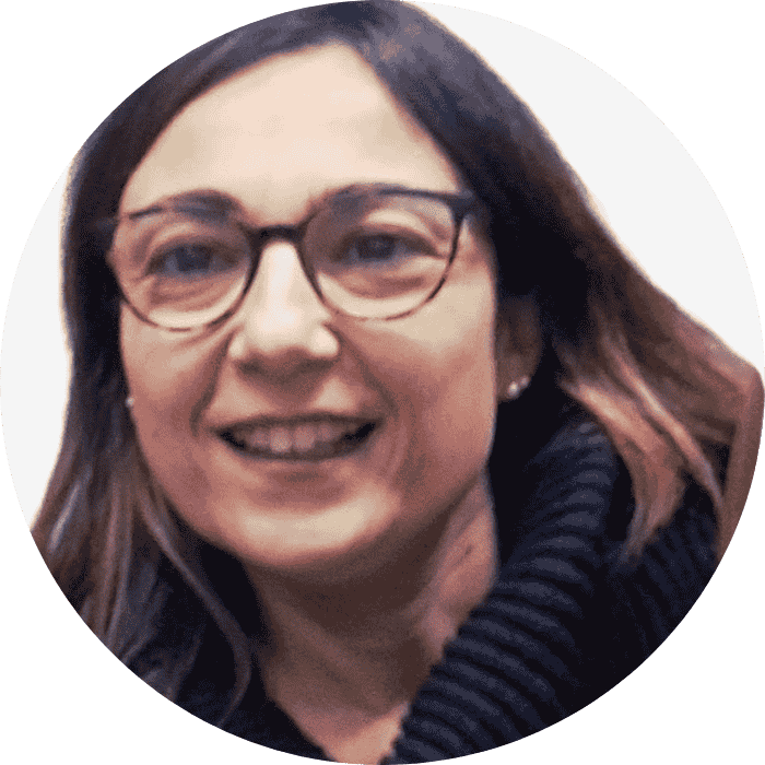 a woman wearing glasses and smiling