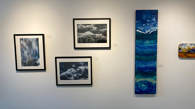 An assortment of artwork arranged on a white wall