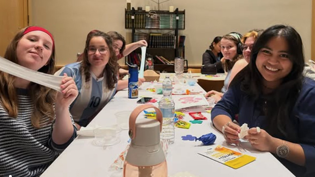 Students at a long table with crafts and stretchy slime.