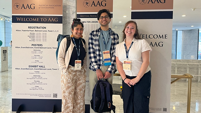 From left: Denise Fernandes, Parsa Keshavarz Alamdari and Rocio Josephine Lybarger-Yanes stand in front of “Welcome to AAG” signage