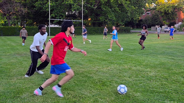 A group of students playing outdoor soccer