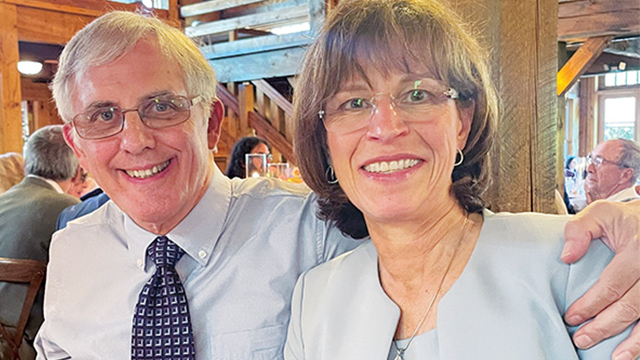 Dave Logan (left) and Holli Logan (right) seated together at a dinner event