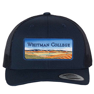 A navy blue trucker hat with a Whitman College patch