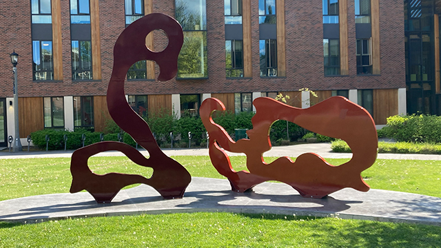 A sculpture featuring two abstract painted metal figures.