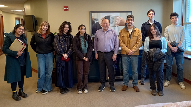 A group of students stand together with Mark Kajita at Baker Boyer Bank