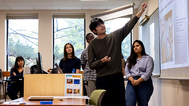 Tabish Navaid leads a presentation in a classroom setting