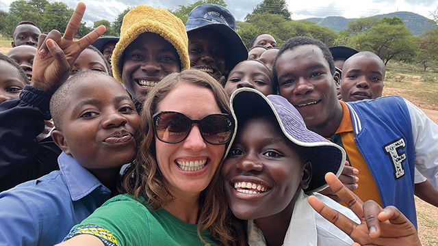 Selfie with Lisa Curtis in the center of a large group of baobab harvesters and their children in Zimbabwe
