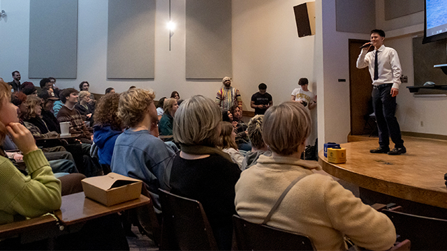 A student speaks to the audience in Olin Auditorium