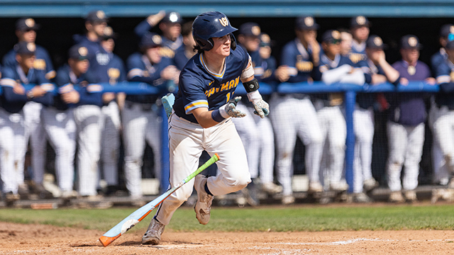 A Whitman baseball player drops the bat and begins running toward first base