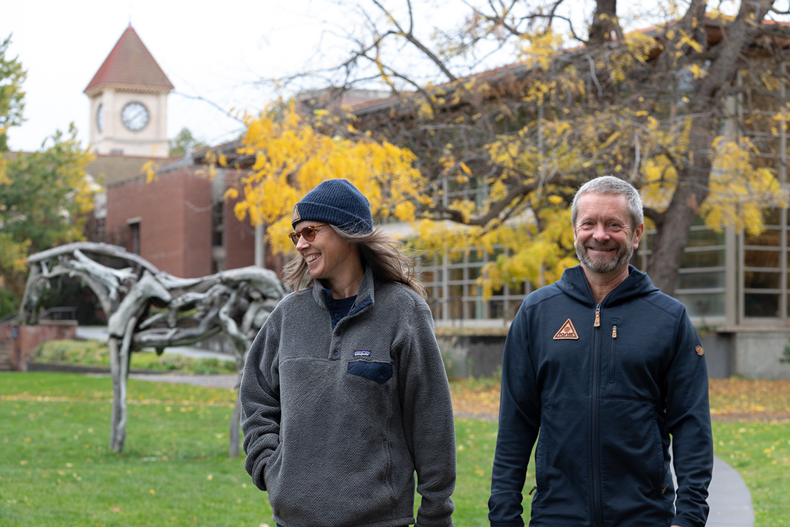 Janna Cawrse Esarey (left) and Graeme Esarey (right) stand near the Styx sculpture in front of Penrose Library