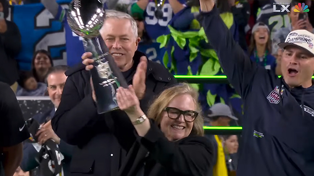 A screenshot of the Super Bowl broadcast showing Jody Allen holding the trophy.