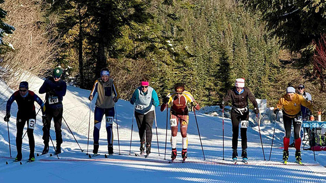 A group of cross-country skiers at the start of a race