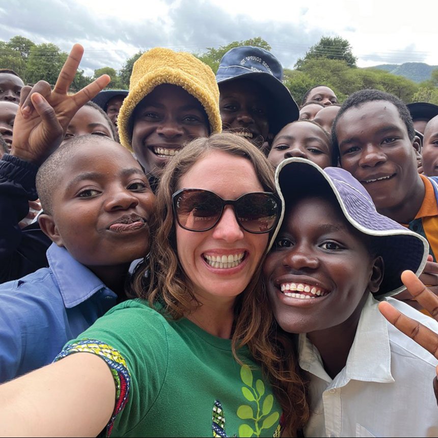 Lisa Curtis (front row, center) poses for a selfie with harvesters and their children in Zimbabwe