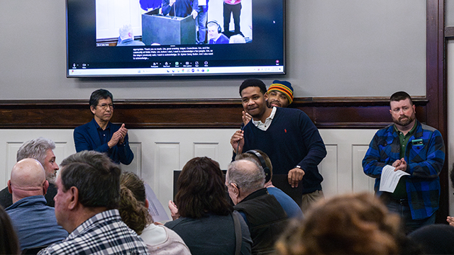 People applauding for a Whitman student speaking at a City Council meeting