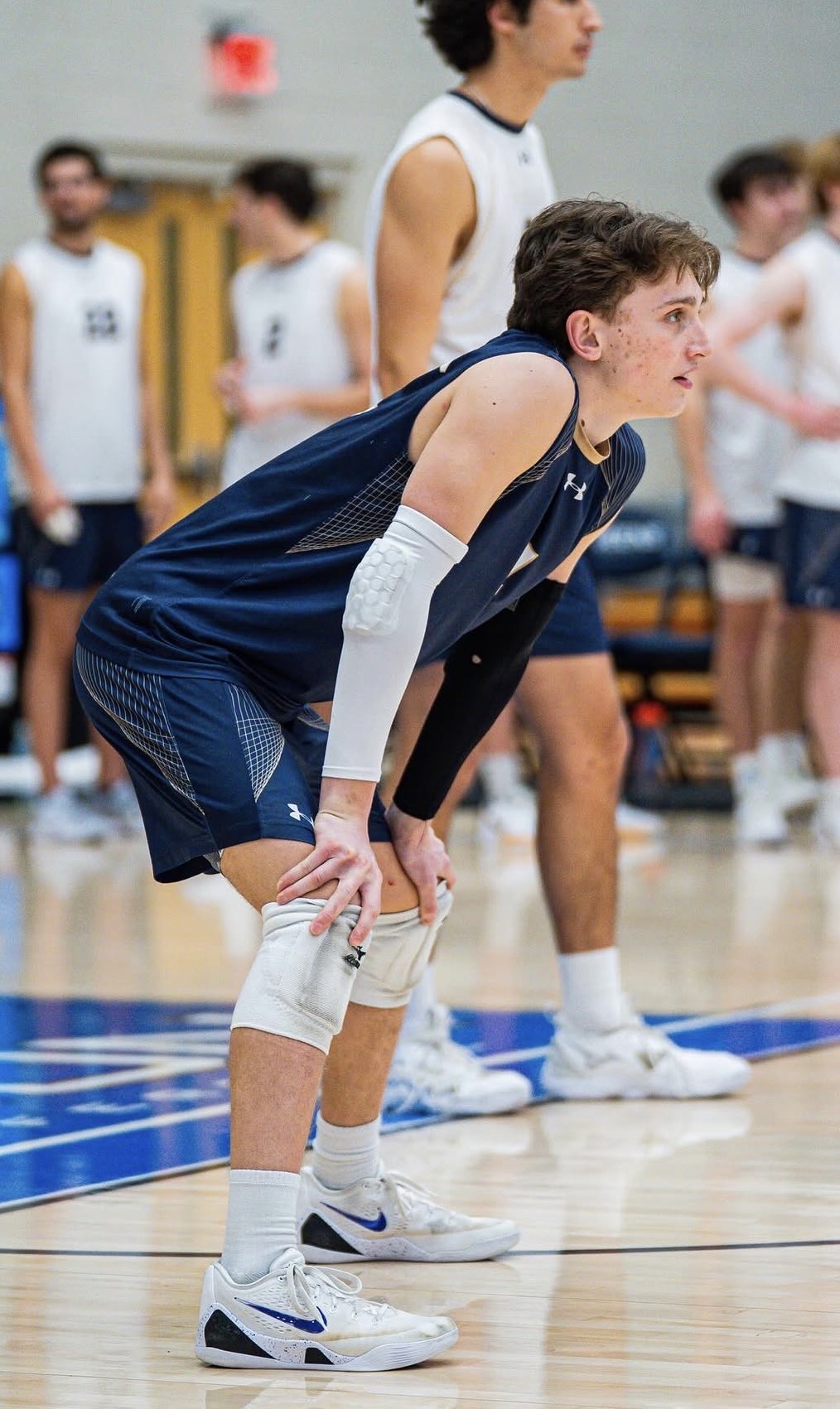 Men's Volleyball player on the court at the Levine Center Men's Volleyball player on the court at the Levine Center