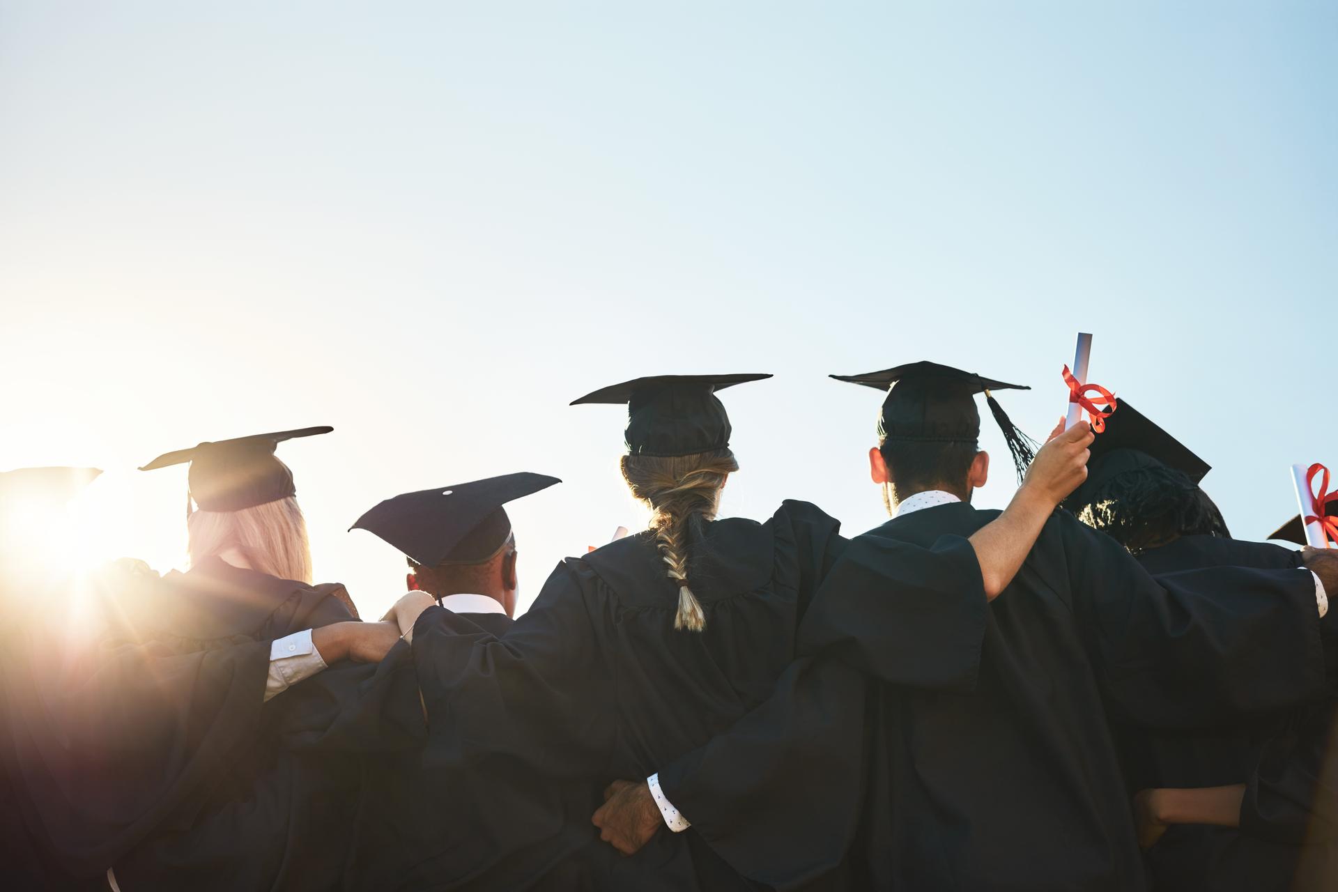 A group of graduates from behind their heads all gathered around
