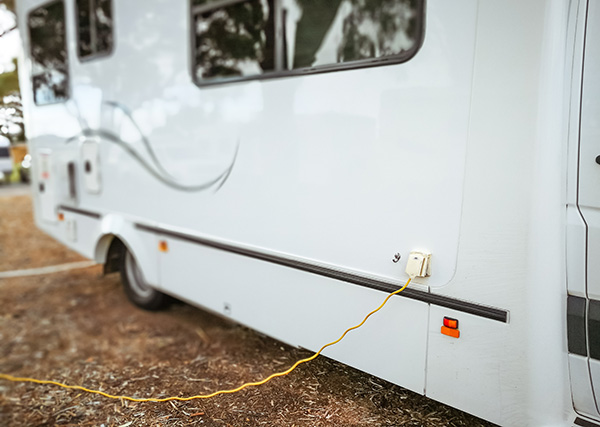 Photo of a camping recreational vehicle with an electrical plug.