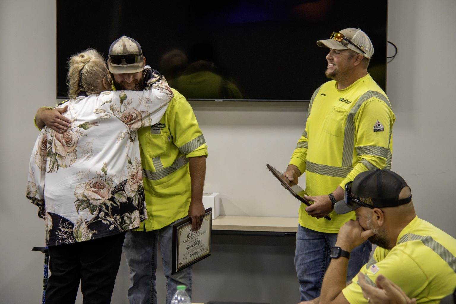 Power linemen hugging the woman they saved