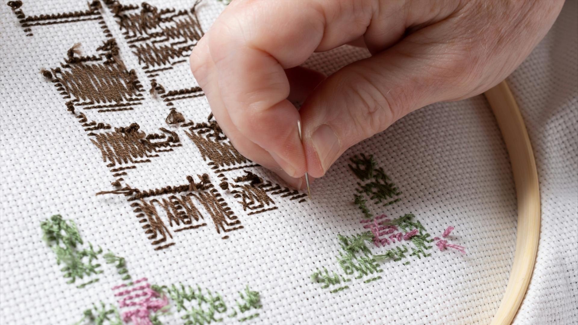 A person needlepointing