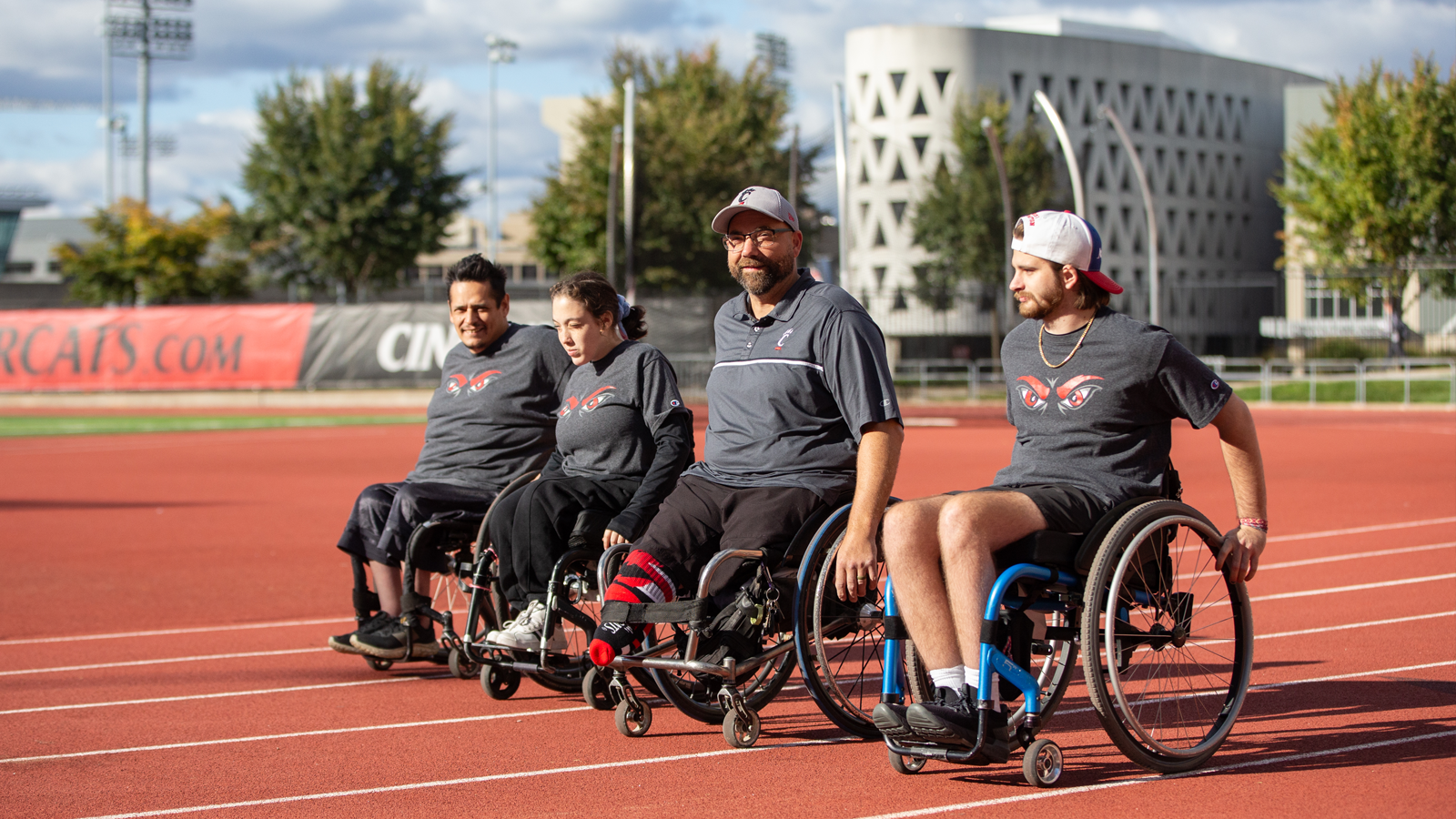 UC Adaptive Athletics athletes gather on the university track